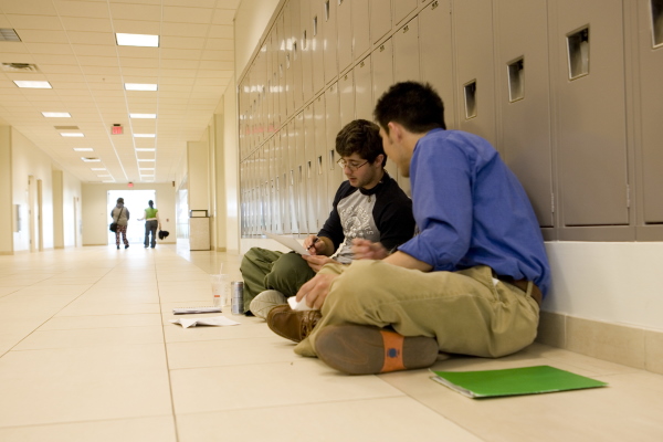 Jindal lockers, student sitting in front of the lockers at the Jindal School 